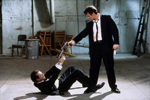 Harvey Keitel and Steve Buscemi pointing guns at each other in Reservoir Dogs